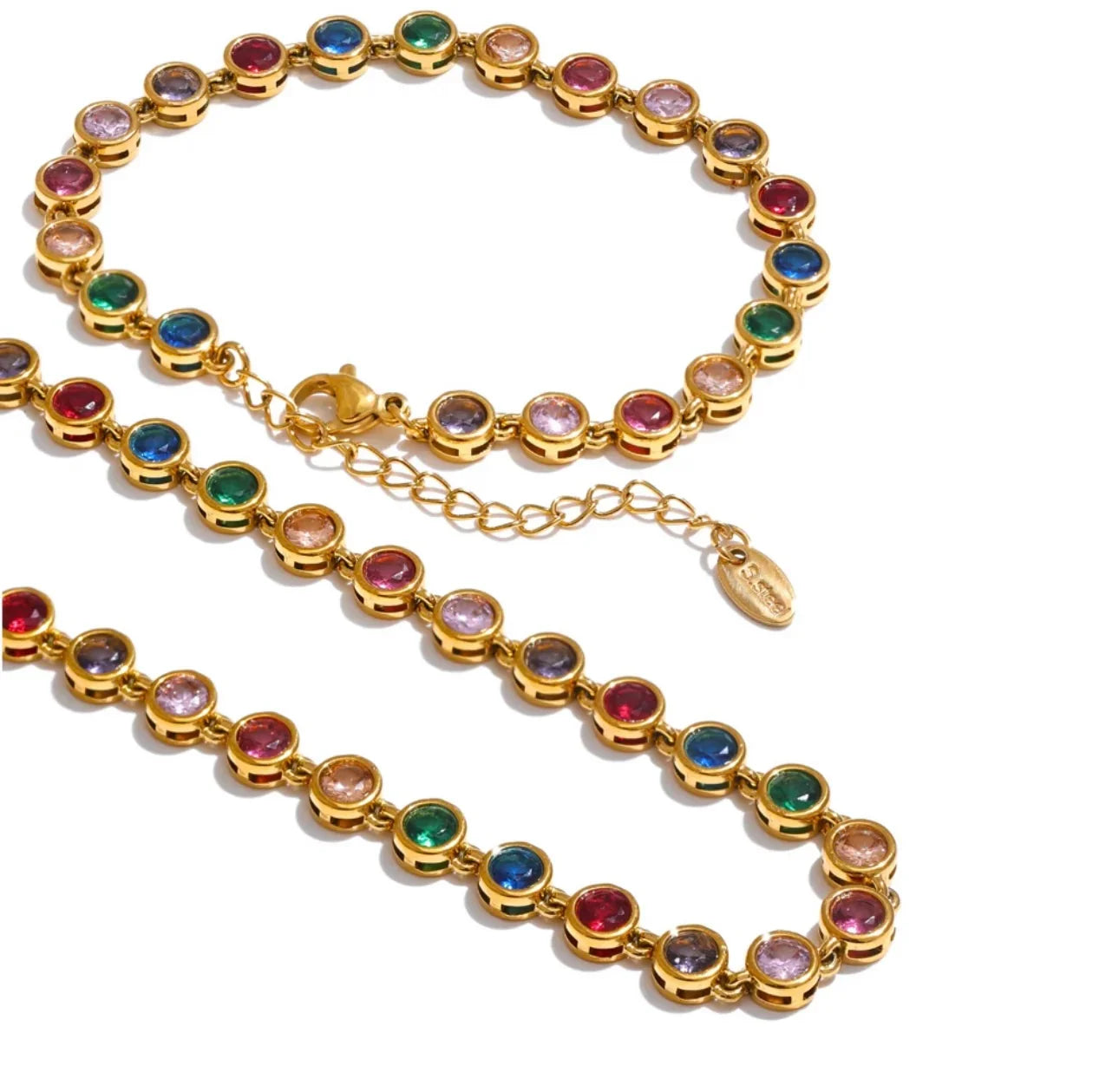 Gold chain necklace and bracelet with round multicolored gemstones on white background