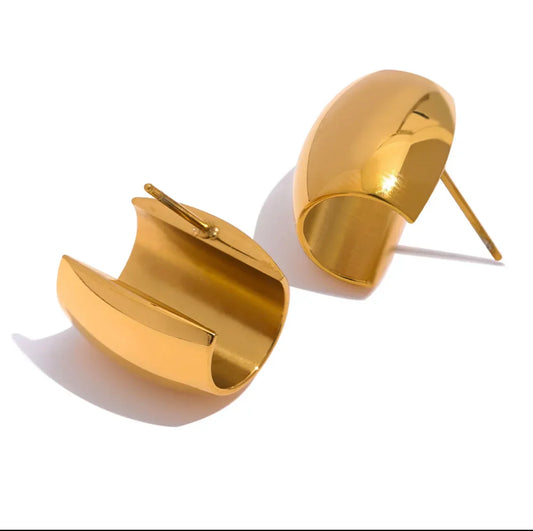 Pair of chunky gold dome stud earrings on white background, modern jewelry style